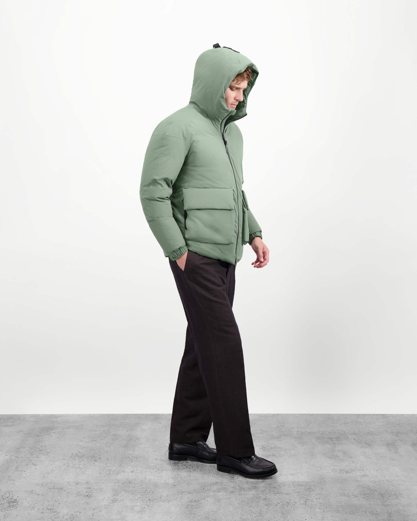 Dixon jacket in Duck Green stretch ripstop fabric with DWR coating, large bellow pockets with magnetic flaps, hidden side-entry zipper pockets, and adjustable cuffs and hem for a tailored fit. Durable, weather-resistant, and versatile.