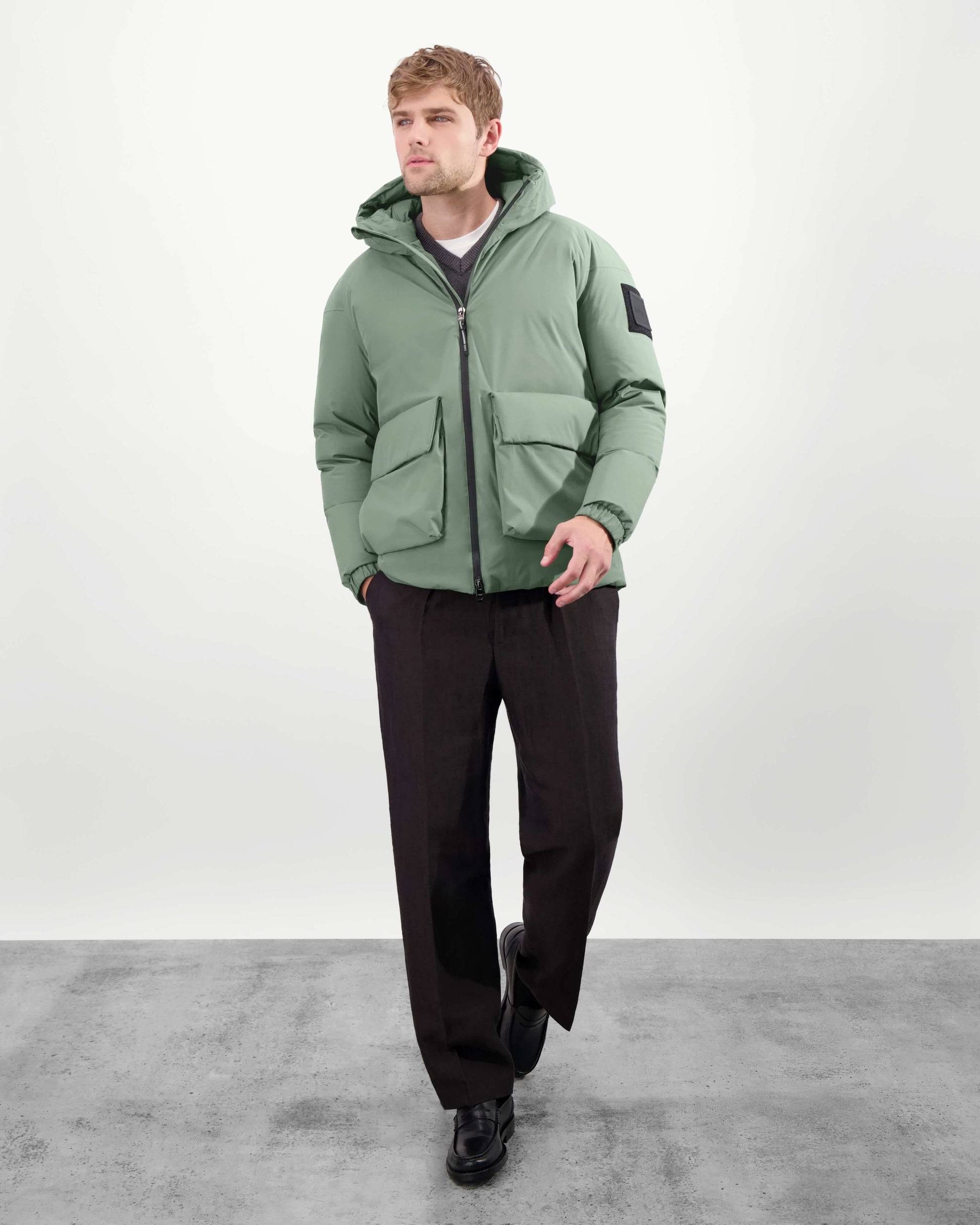 Dixon jacket in Duck Green stretch ripstop fabric with DWR coating, large bellow pockets with magnetic flaps, hidden side-entry zipper pockets, and adjustable cuffs and hem for a tailored fit. Durable, weather-resistant, and versatile.