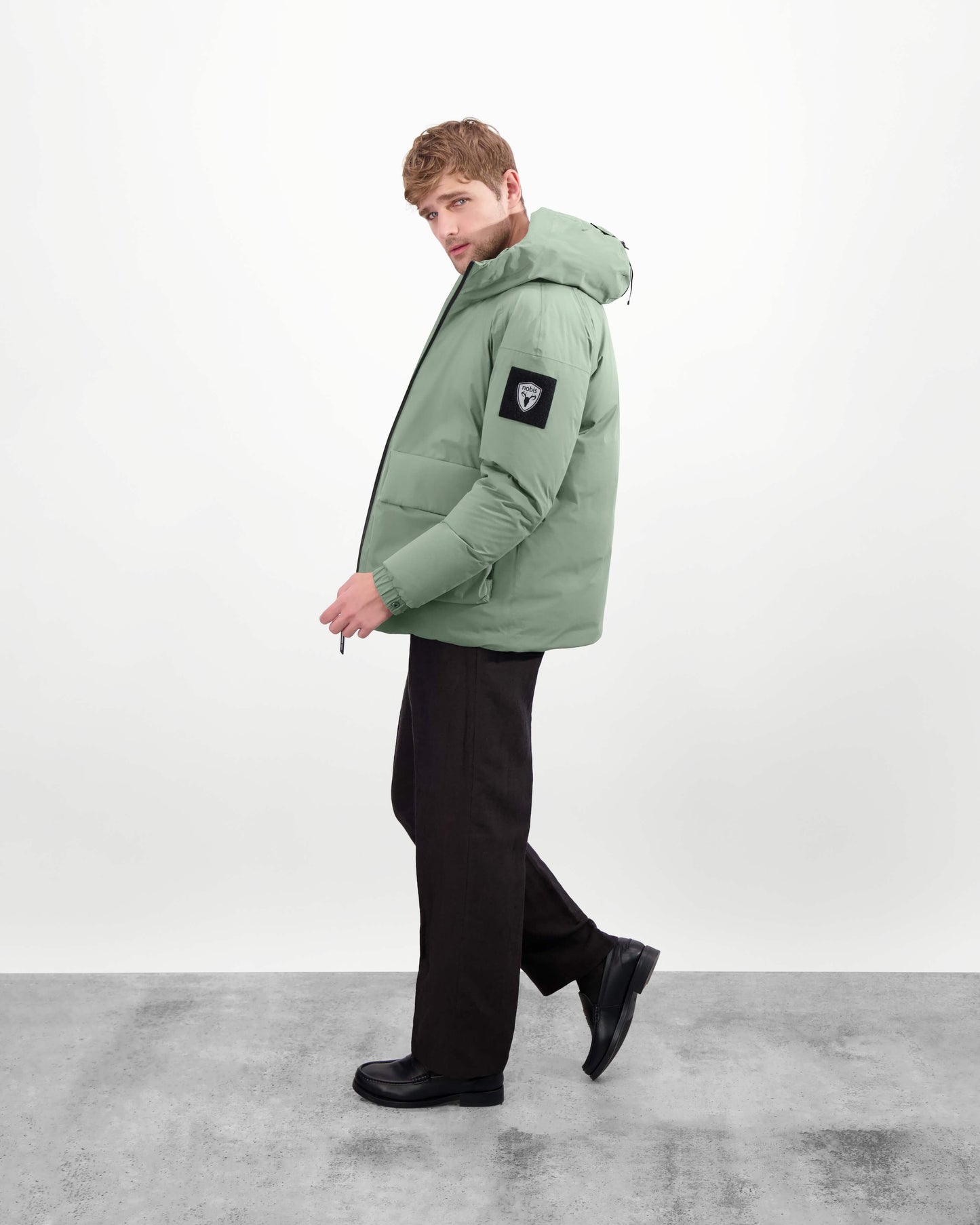 Dixon jacket in Duck Green stretch ripstop fabric with DWR coating, large bellow pockets with magnetic flaps, hidden side-entry zipper pockets, and adjustable cuffs and hem for a tailored fit. Durable, weather-resistant, and versatile.