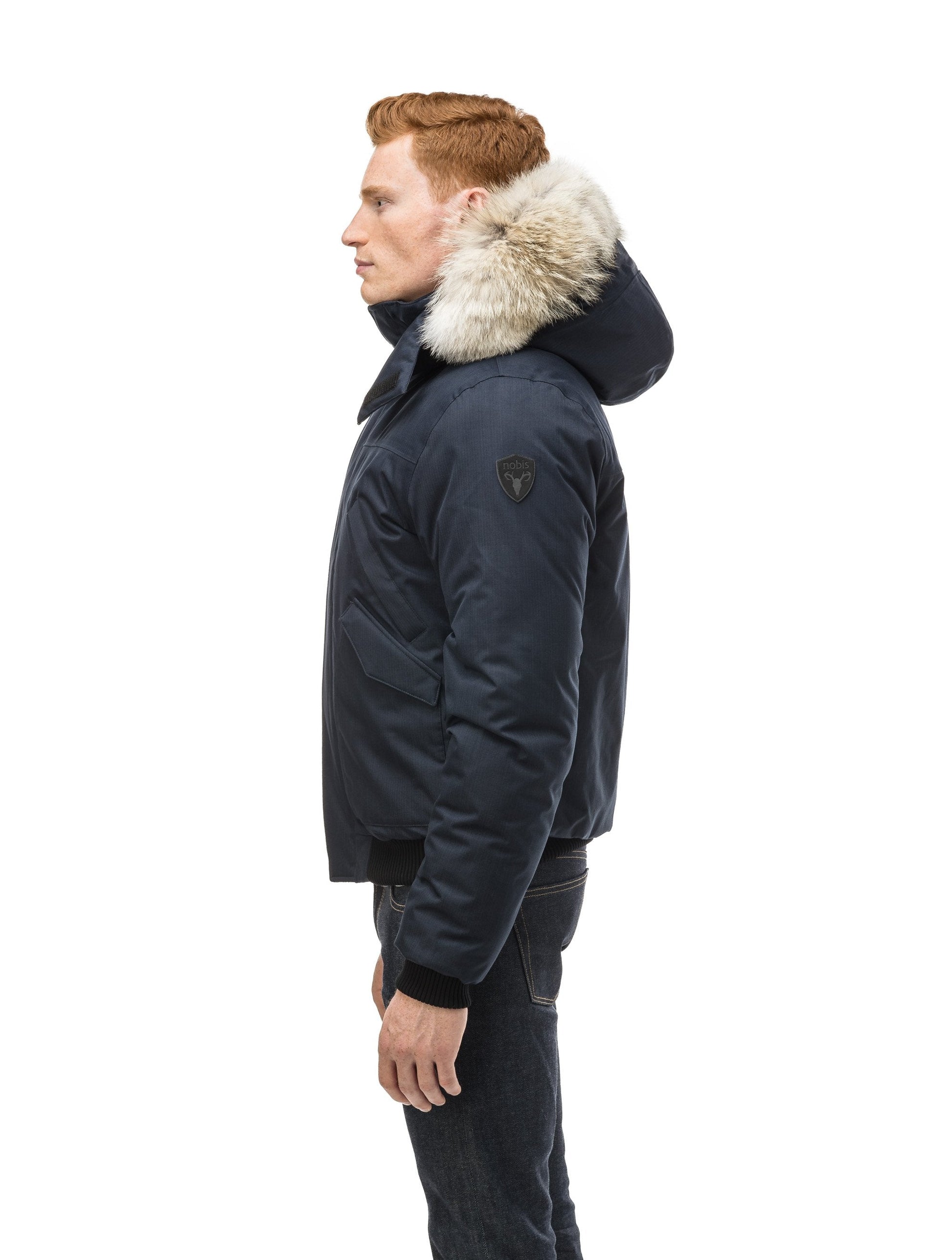 Men's classic down filled bomber jacket with a down filledÃƒÆ’Ã†â€™Ãƒâ€ Ã¢â‚¬â„¢ÃƒÆ’Ã¢â‚¬Â ÃƒÂ¢Ã¢â€šÂ¬Ã¢â€žÂ¢ÃƒÆ’Ã†â€™Ãƒâ€šÃ‚Â¢ÃƒÆ’Ã‚Â¢ÃƒÂ¢Ã¢â€šÂ¬Ã…Â¡Ãƒâ€šÃ‚Â¬ÃƒÆ’Ã¢â‚¬Â¦Ãƒâ€šÃ‚Â¡ÃƒÆ’Ã†â€™Ãƒâ€ Ã¢â‚¬â„¢ÃƒÆ’Ã‚Â¢ÃƒÂ¢Ã¢â‚¬Å¡Ã‚Â¬Ãƒâ€¦Ã‚Â¡ÃƒÆ’Ã†â€™ÃƒÂ¢Ã¢â€šÂ¬Ã…Â¡ÃƒÆ’Ã¢â‚¬Å¡Ãƒâ€šÃ‚Â hood that features a removable coyote fur trim and concealed moldable framing wire in Navy