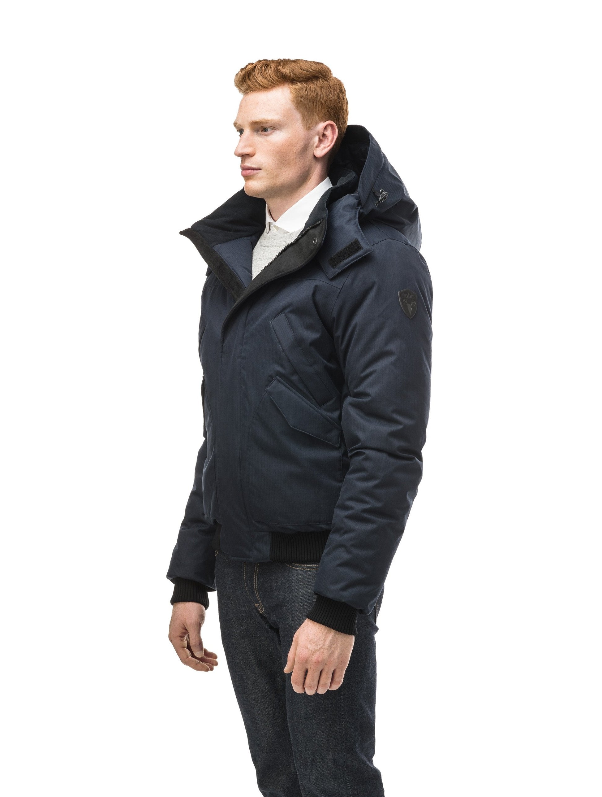 Men's classic down filled bomber jacket with a down filledÃƒÆ’Ã†â€™Ãƒâ€ Ã¢â‚¬â„¢ÃƒÆ’Ã¢â‚¬Â ÃƒÂ¢Ã¢â€šÂ¬Ã¢â€žÂ¢ÃƒÆ’Ã†â€™Ãƒâ€šÃ‚Â¢ÃƒÆ’Ã‚Â¢ÃƒÂ¢Ã¢â€šÂ¬Ã…Â¡Ãƒâ€šÃ‚Â¬ÃƒÆ’Ã¢â‚¬Â¦Ãƒâ€šÃ‚Â¡ÃƒÆ’Ã†â€™Ãƒâ€ Ã¢â‚¬â„¢ÃƒÆ’Ã‚Â¢ÃƒÂ¢Ã¢â‚¬Å¡Ã‚Â¬Ãƒâ€¦Ã‚Â¡ÃƒÆ’Ã†â€™ÃƒÂ¢Ã¢â€šÂ¬Ã…Â¡ÃƒÆ’Ã¢â‚¬Å¡Ãƒâ€šÃ‚Â hood that features a removable coyote fur trim and concealed moldable framing wire in Navy