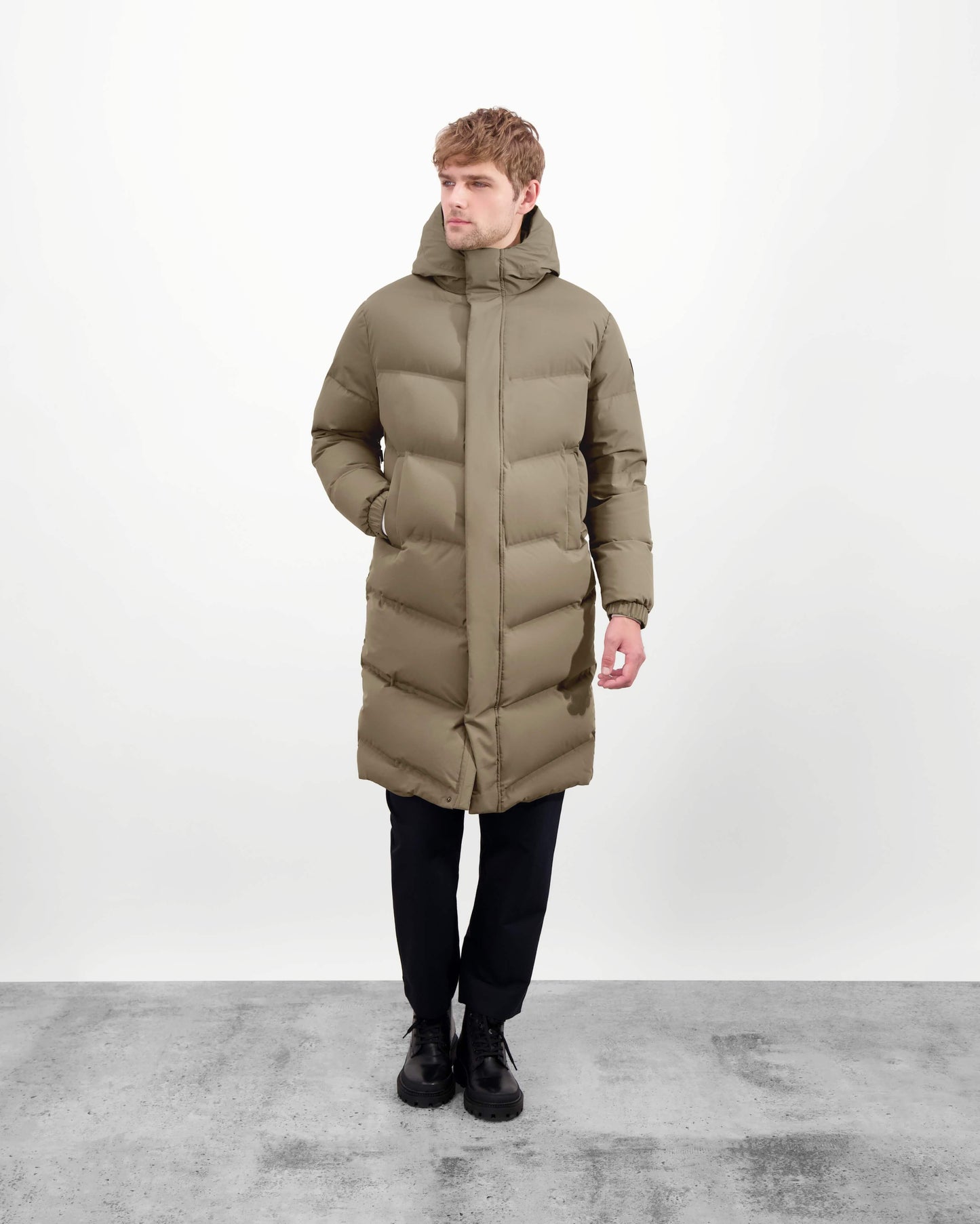 Granger long jacket in Bungee Cord stretch ripstop fabric with DWR coating, insulated with Canadian white duck down and Primaloft. Features a two-way zipper, magnetic closure, and adjustable cuffs for warmth and weather protection.