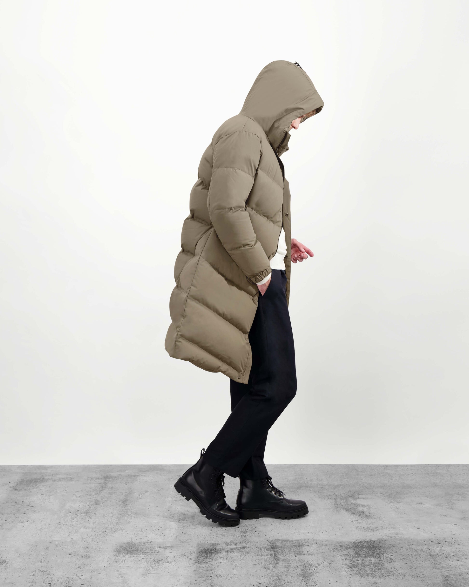 Granger long jacket in Bungee Cord stretch ripstop fabric with DWR coating, insulated with Canadian white duck down and Primaloft. Features a two-way zipper, magnetic closure, and adjustable cuffs for warmth and weather protection.