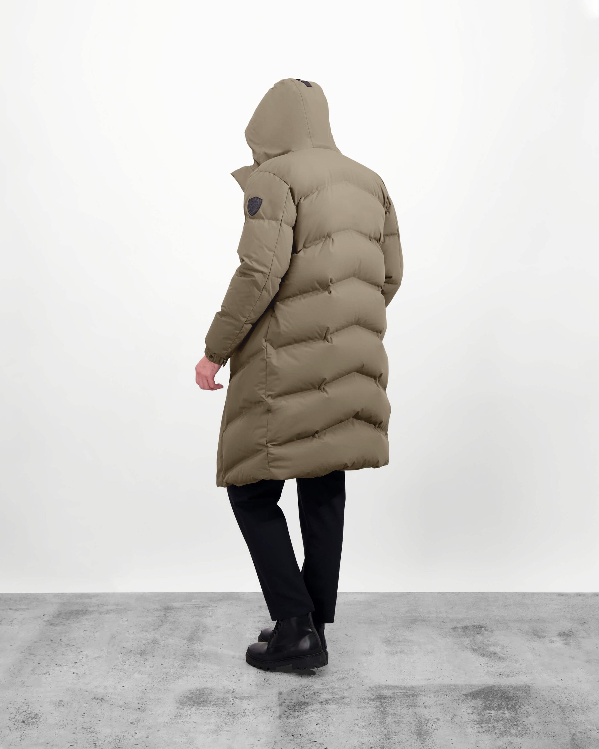 Granger long jacket in Bungee Cord stretch ripstop fabric with DWR coating, insulated with Canadian white duck down and Primaloft. Features a two-way zipper, magnetic closure, and adjustable cuffs for warmth and weather protection.