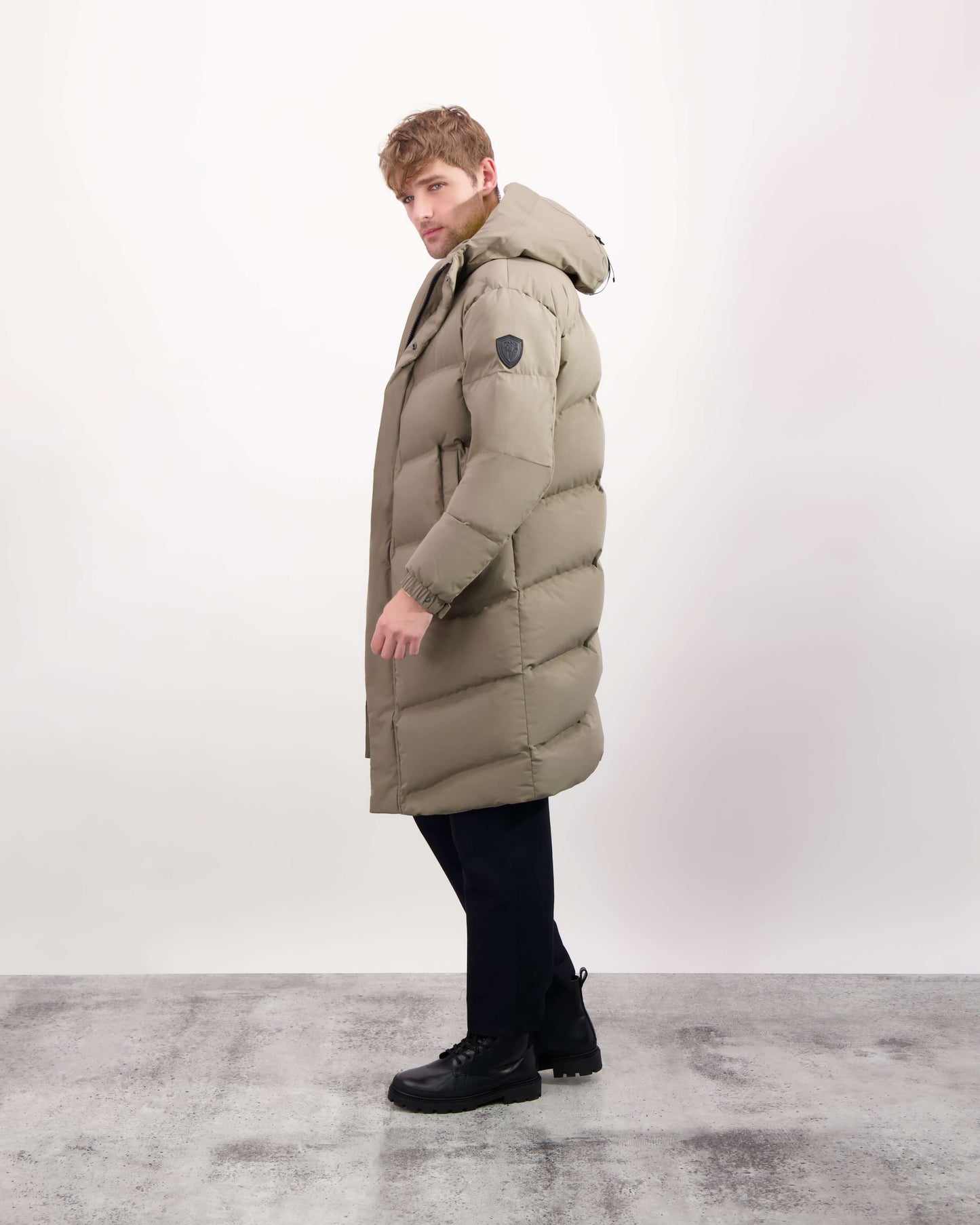 Granger long jacket in Bungee Cord stretch ripstop fabric with DWR coating, insulated with Canadian white duck down and Primaloft. Features a two-way zipper, magnetic closure, and adjustable cuffs for warmth and weather protection.