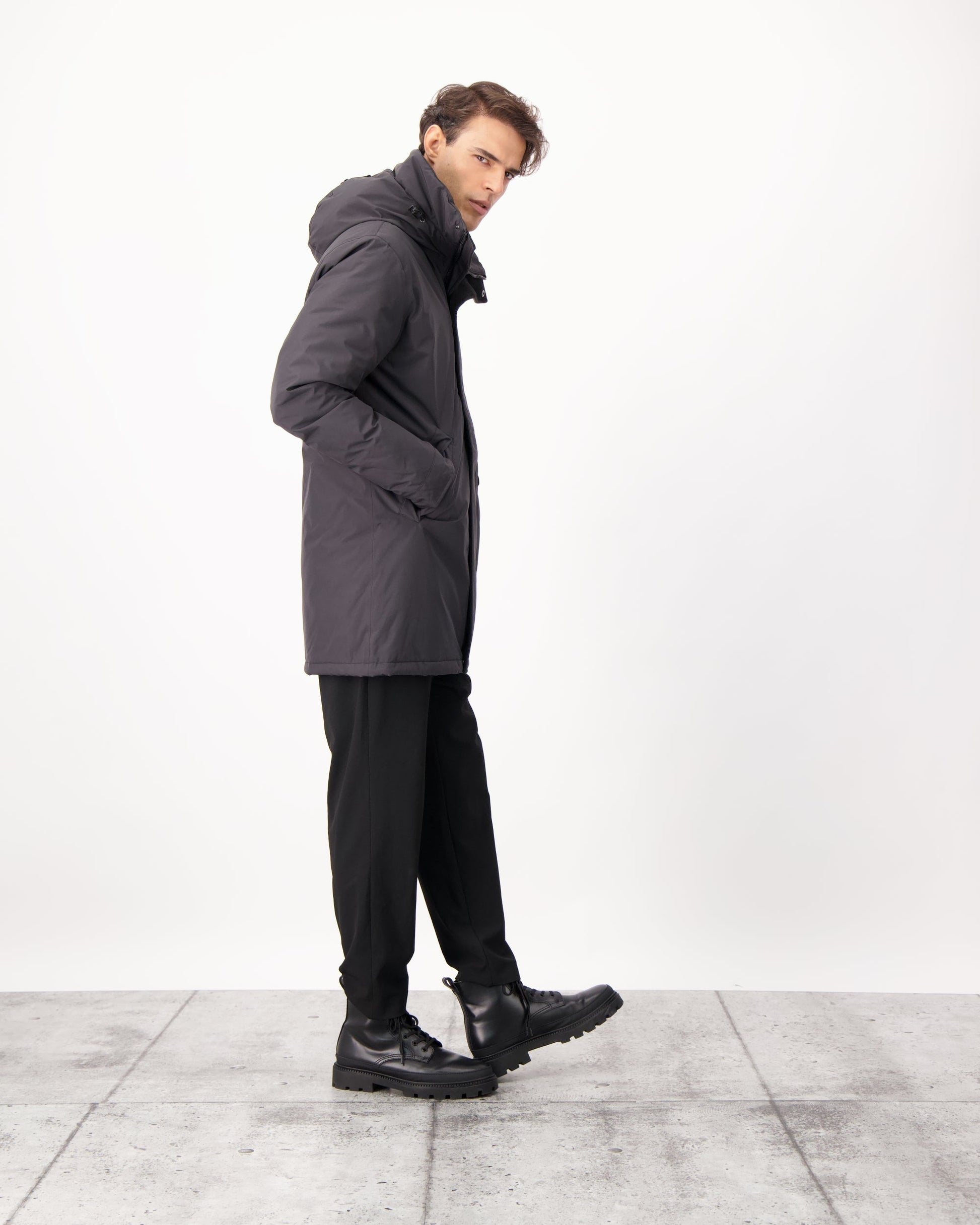 Pierre Men's Jacket in thigh length, Canadian white duck down insulation, non-removable down-filled hood, angled waist pockets, centre-front zipper with wind flap, and elastic ribbed cuffs, in 3L Black