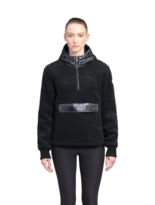 Roche Women's Hybrid Berber Pullover Hoodie in hip length, premium berber and cire technical nylon taffeta fabrication, Primaloft Gold Insulation Active+, non-removable hood with zipper at collar, kangaroo pocket with magnetic closure flap and additional side-entry pockets, ribbed cuffs, adjustable drawcords at side hem, in Black