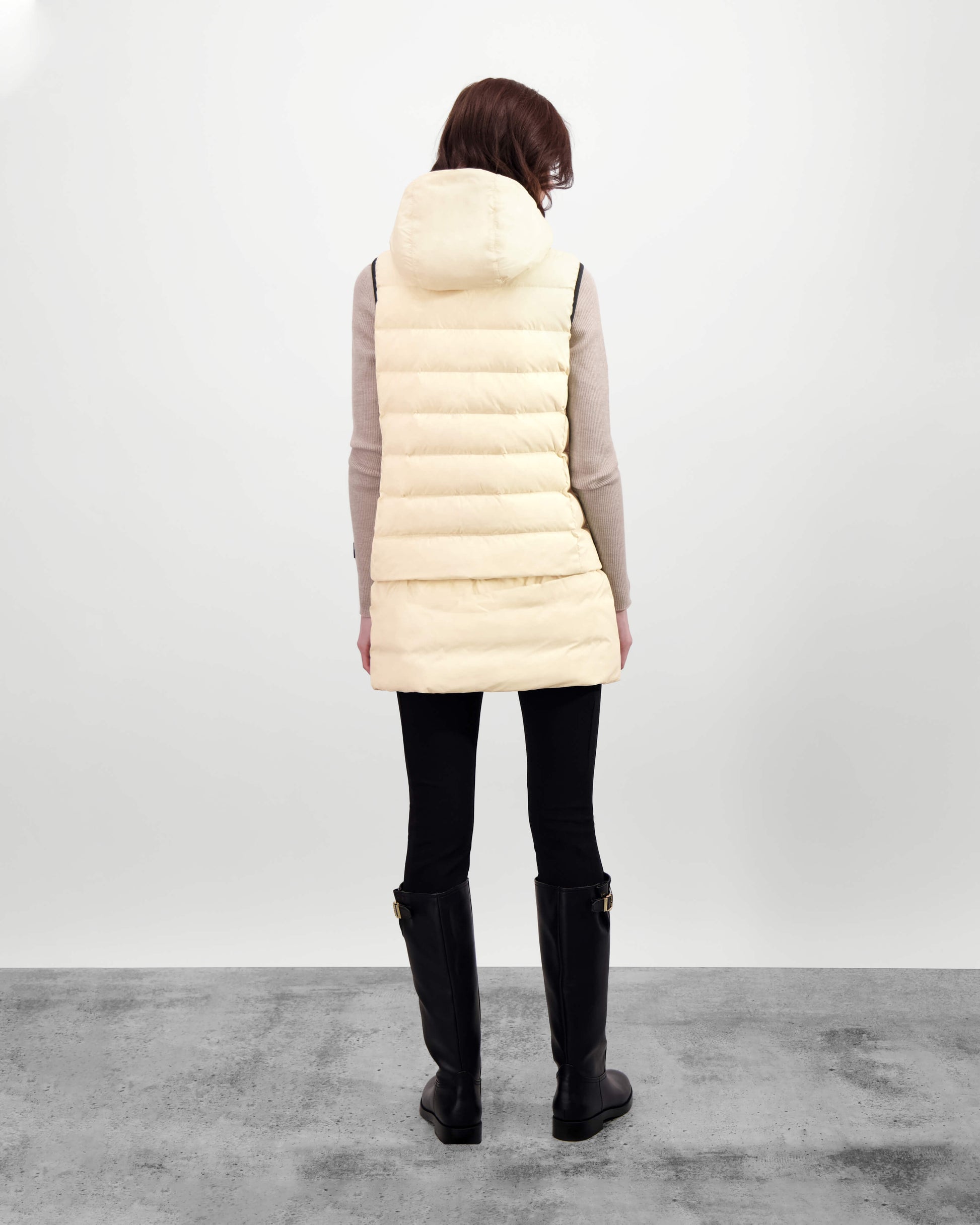 Saratoga puffer vest in Wheat insulated with Canadian white duck down, featuring stretch nylon ribbing for mobility, hidden waist drawcord, and a tailored fit for warmth and style. Lightweight and ideal for layering.