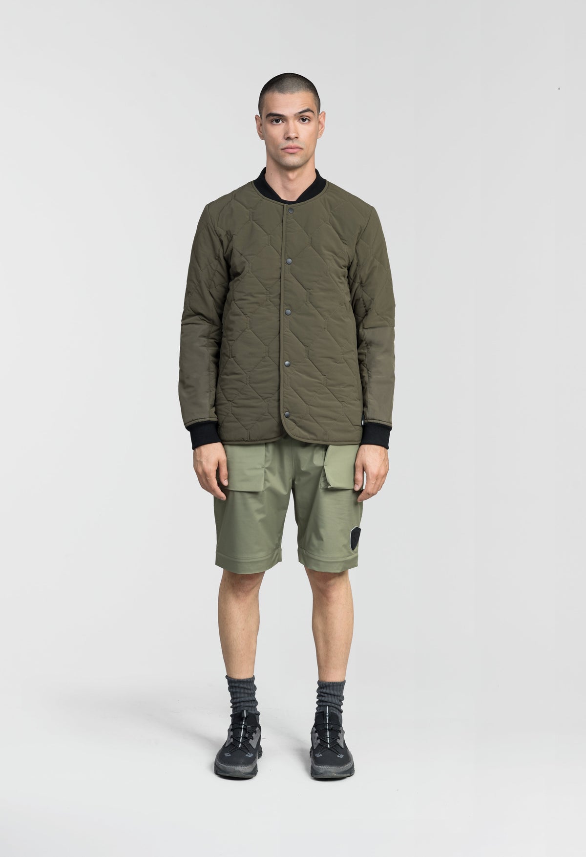 Speck Men's Tailored Mid Layer Jacket in hip length, Primaloft Gold Insulation Active+, diamond quilted body, rib knit collar and cuffs, snap buton front closure, and hidden side-entry zipper pockets at waist, in Fatigue