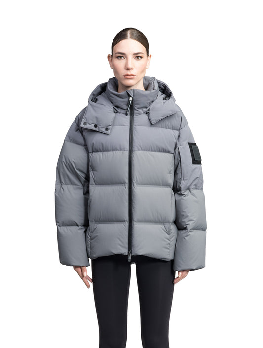 Una Ladies Performance Puffer in hip length, Technical Taffeta and Durable Stretch Ripstop fabrication, Premium Canadian White Duck Down insulation, removable down filled hood, centre front two-way zipper, and side-entry pockets at waist, in Concrete + Concrete