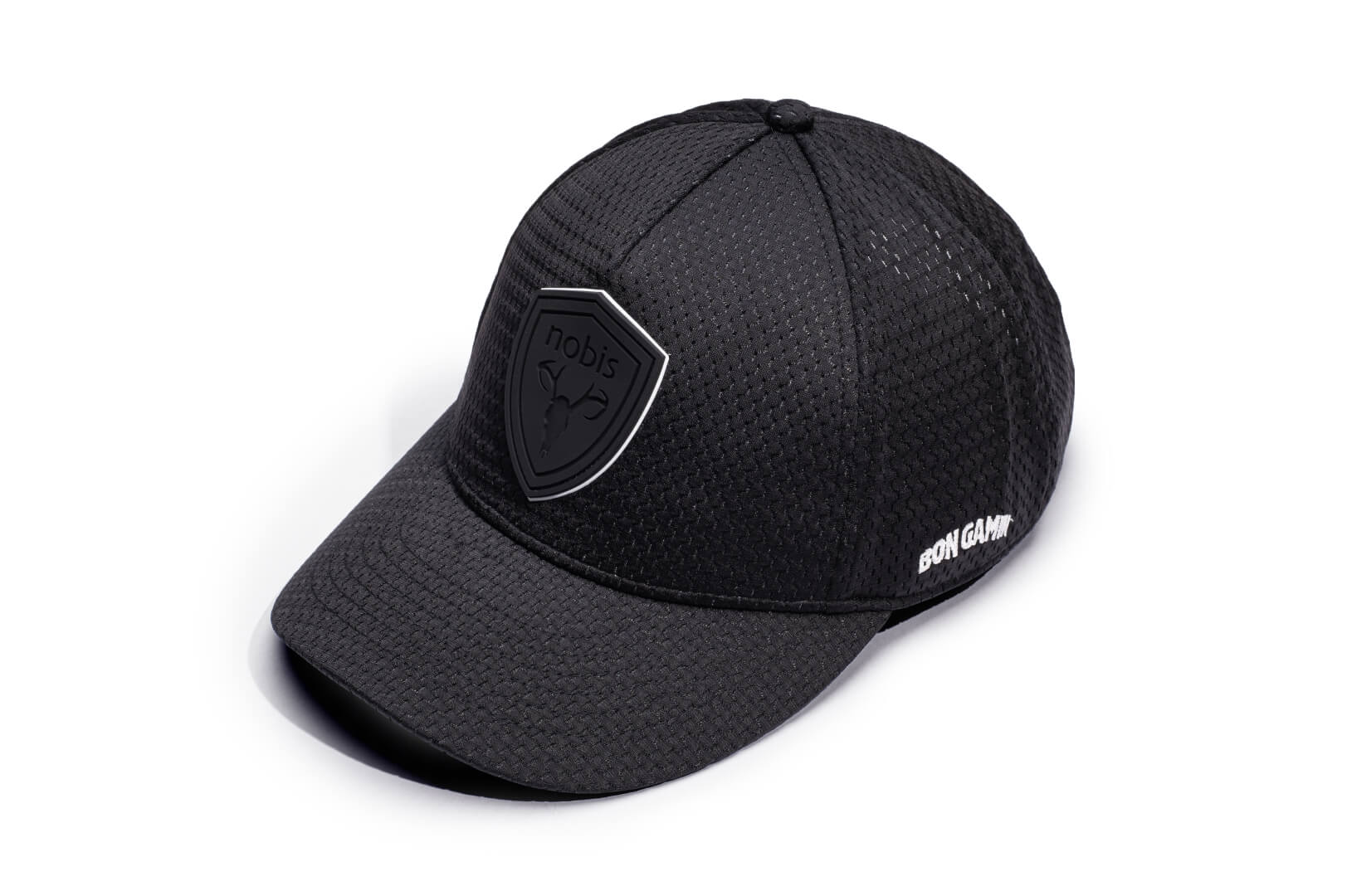 Ciryl Gane x Nobis 5-Panel Adjustable Cap in 5-panel jersey construction, curved brim, adjustable strap at back, tonal black Nobis shield logo attached on crown front, "Bon Gamin" embroidered on the left, and flag of France embroidered on the back, in Black