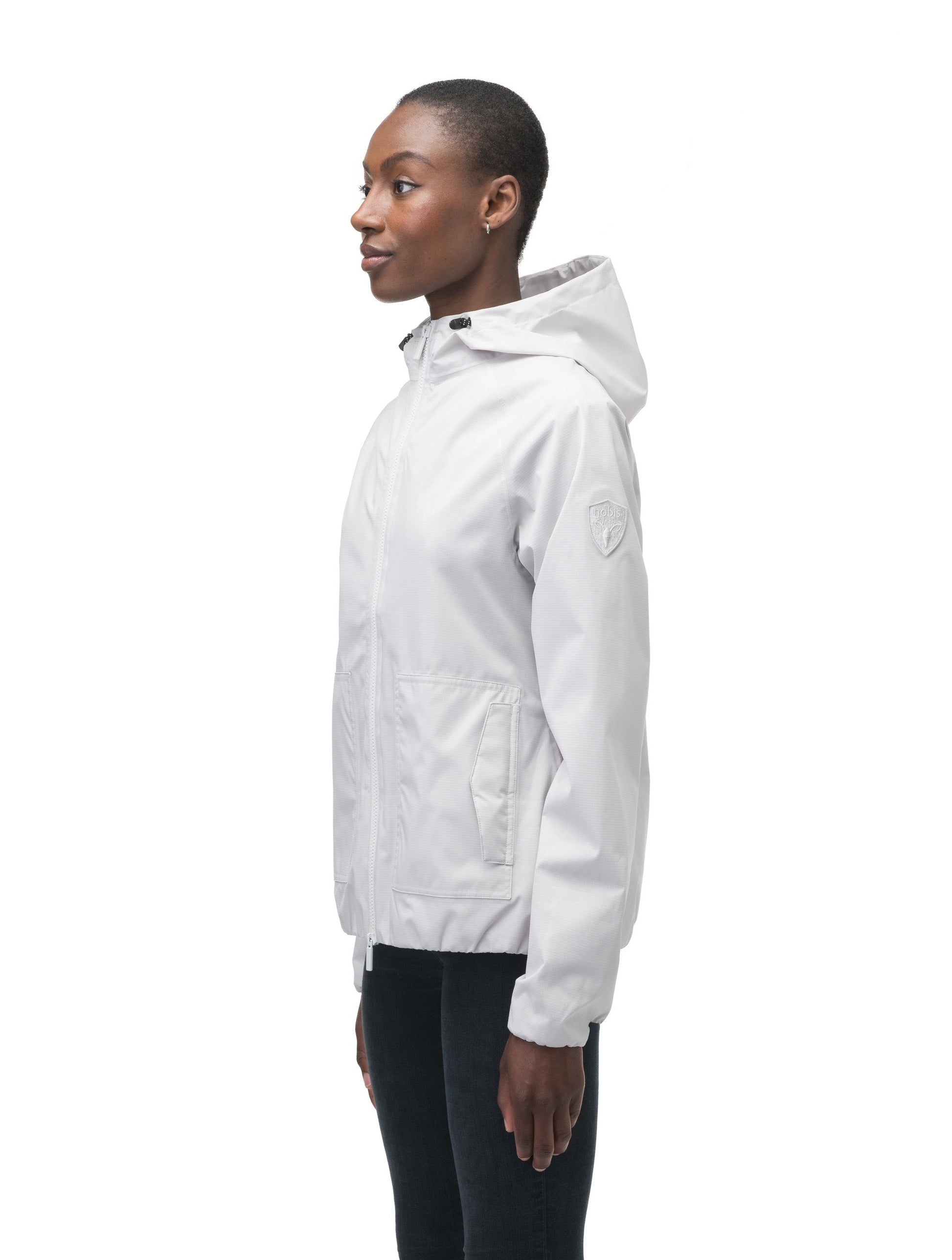 Women's hip length waterproof jacket with non-removable hood and two-way zipper in Light Grey