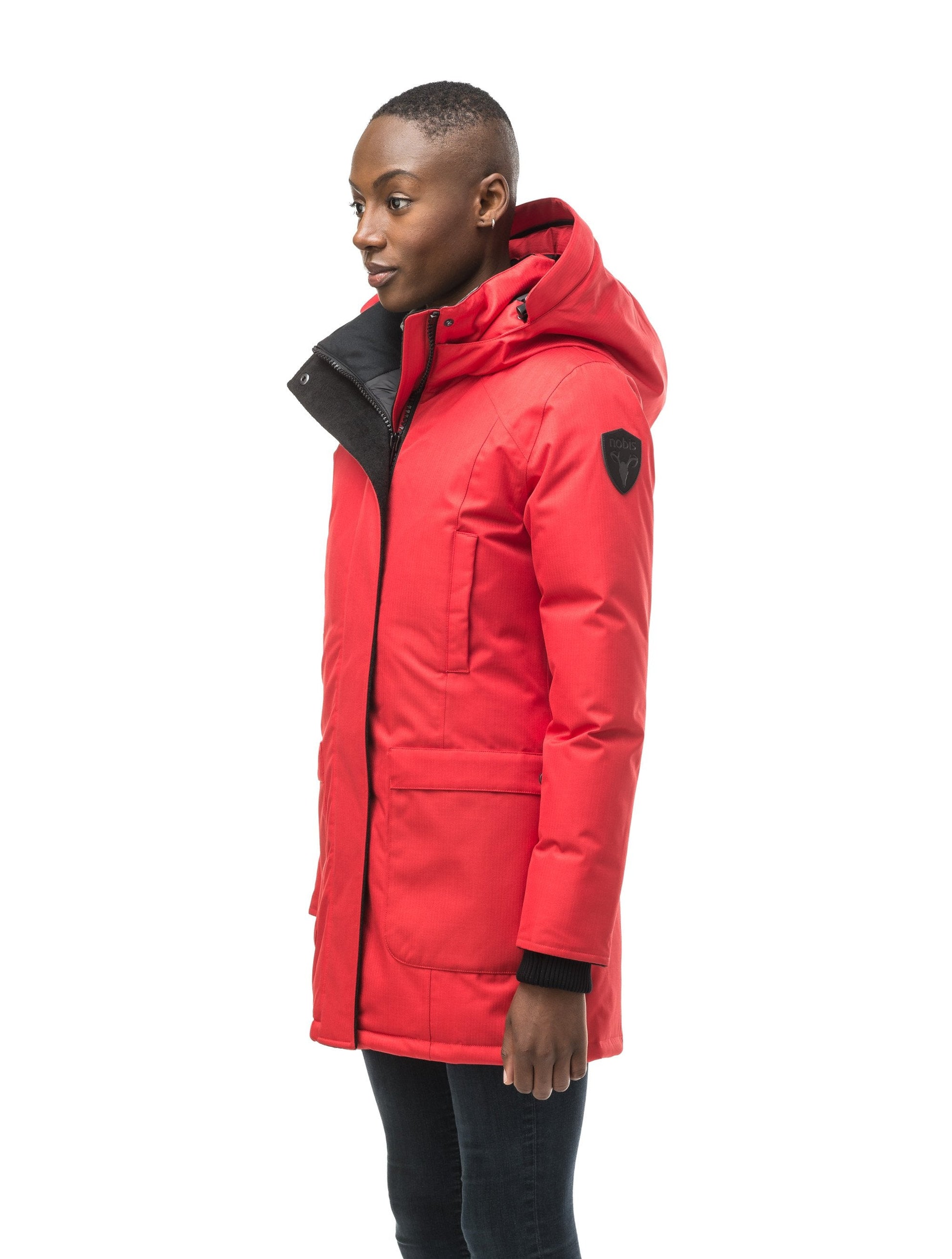Women's down filled parka that sits just below the hip with a clean look and two hip patch pockets in CH Red