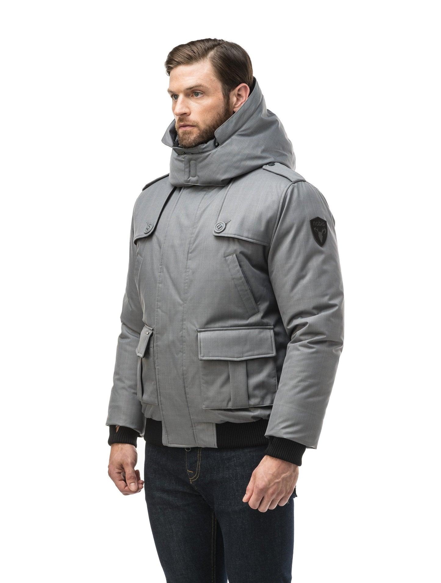 Men's down filled bomber that sits just above the hips with a completely removable hood that's windproof, waterproof, and breathable in CH Concrete