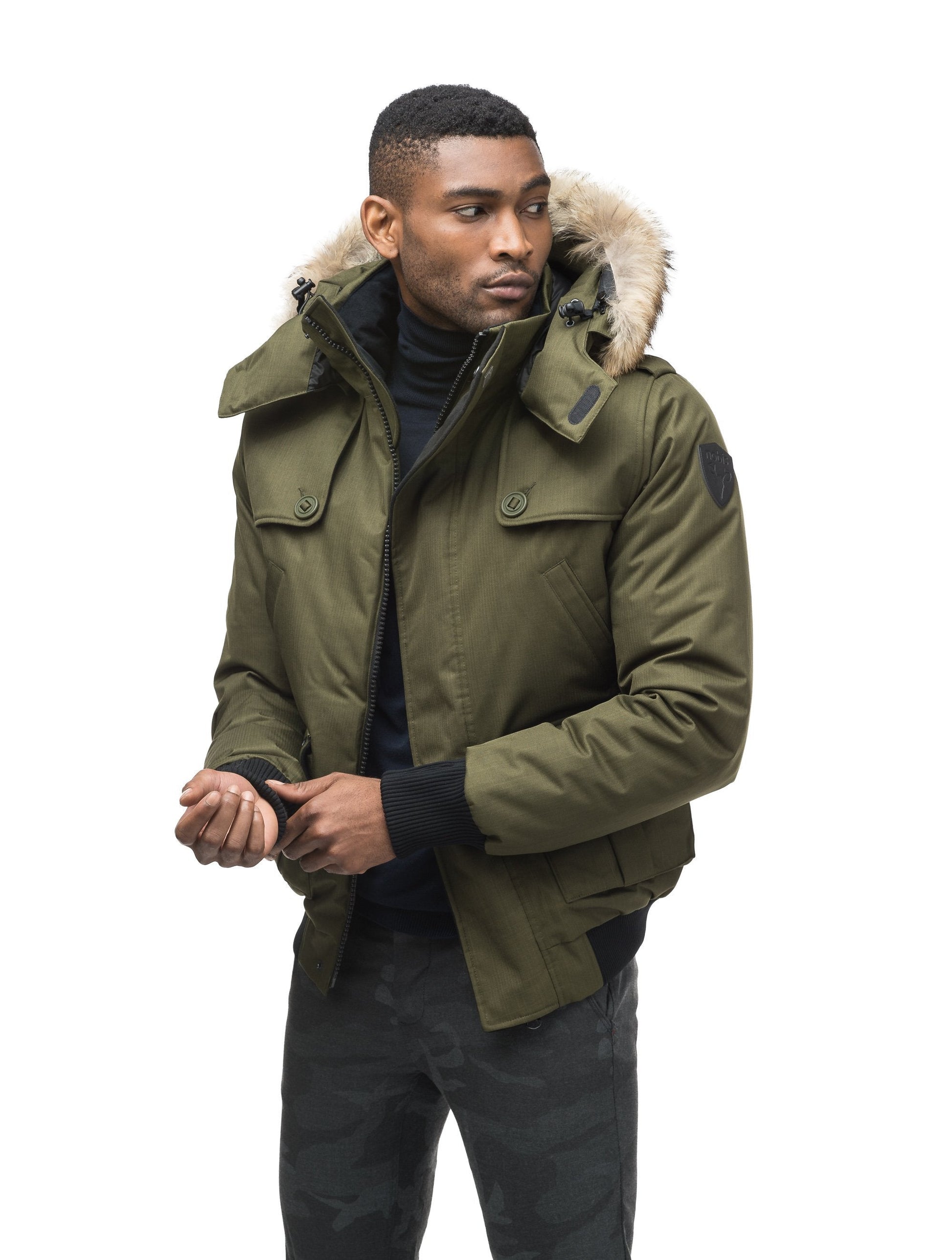 Men's down filled bomber that sits just above the hips with a completely removable hood that's windproof, waterproof, and breathable in CH Fatigue