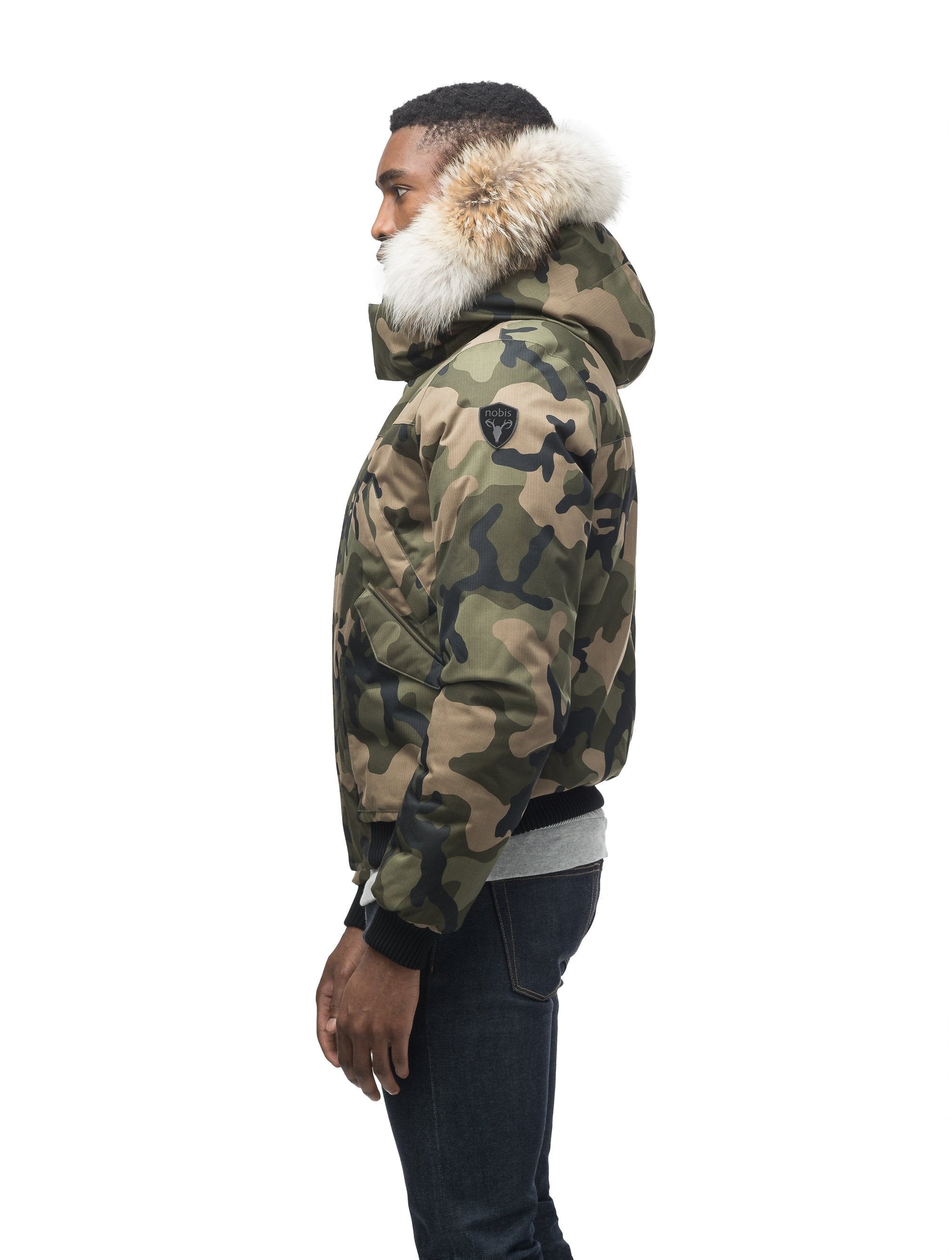Men's classic down filled bomber jacket with a down filledÂ hood that features a removable coyote fur trim and concealed moldable framing wire in Camo
