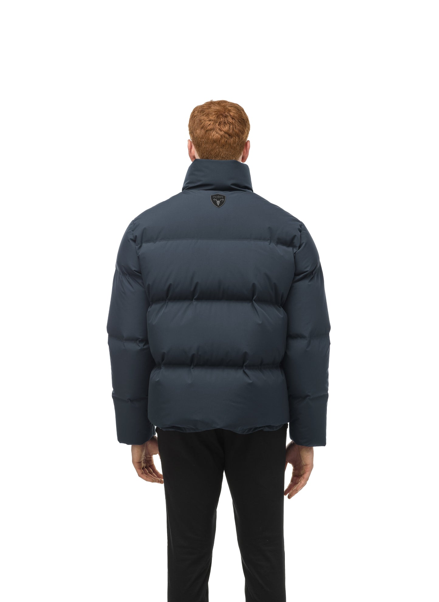 Men's puffer jacket with a minimalist modern design; featuring graphic details like oversized tonal branding, an exposed zipper, and seamless puffer channels in Midnight Blue