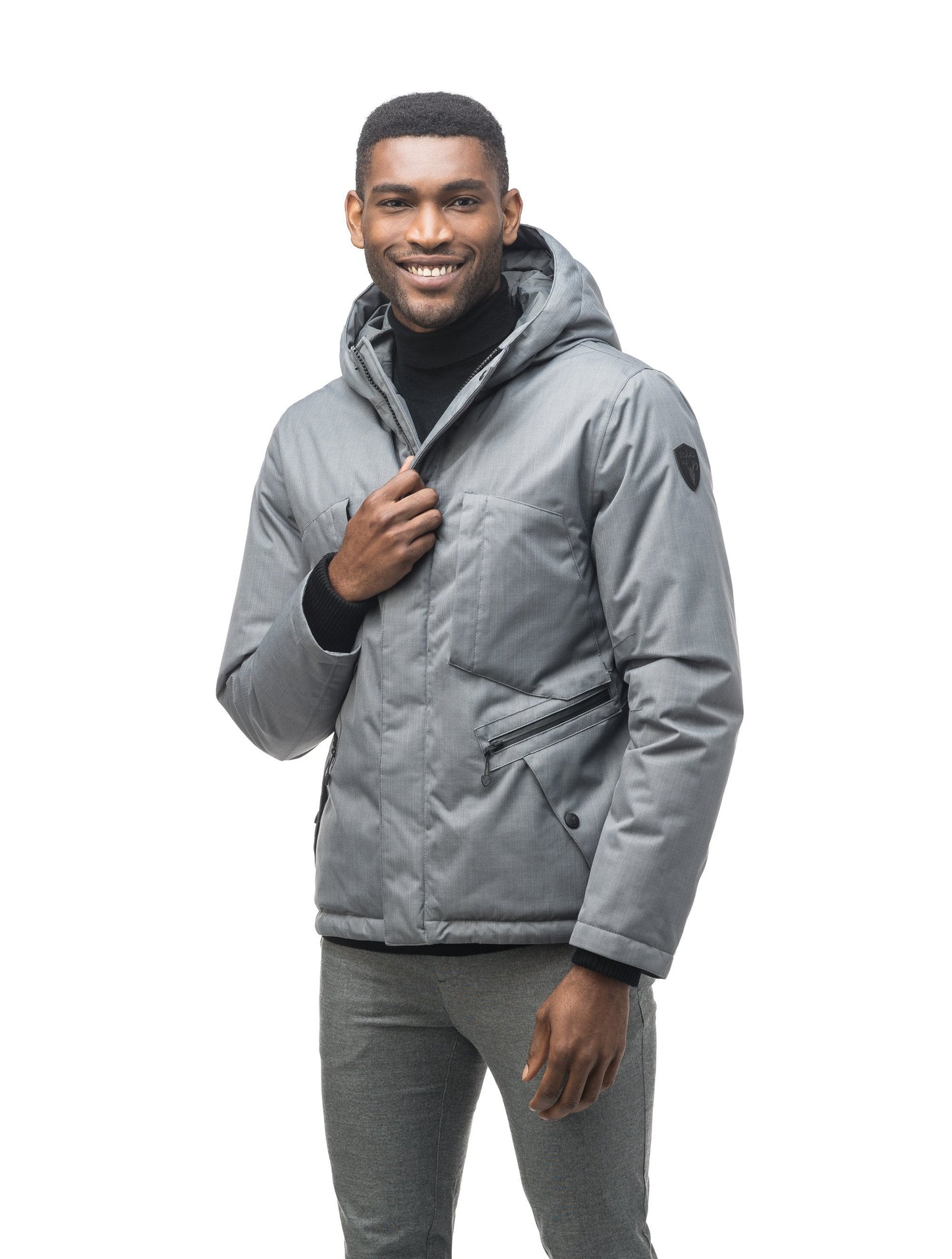 Men's waist length light down coat equipped with six exterior pockets and a hood in Concrete