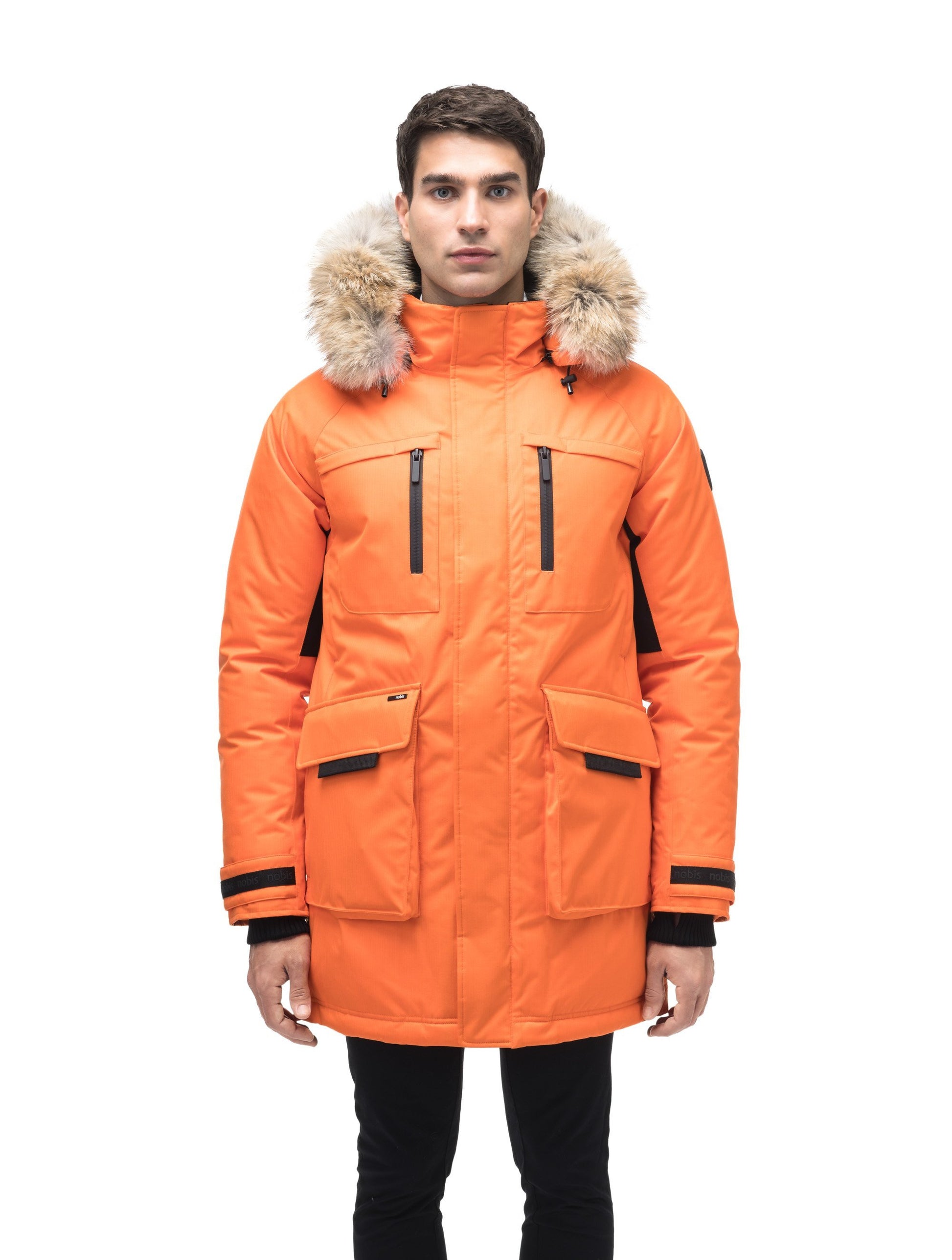 Men's thigh length down-filled parka with removable hood and removable coyote fur trim in Atomic