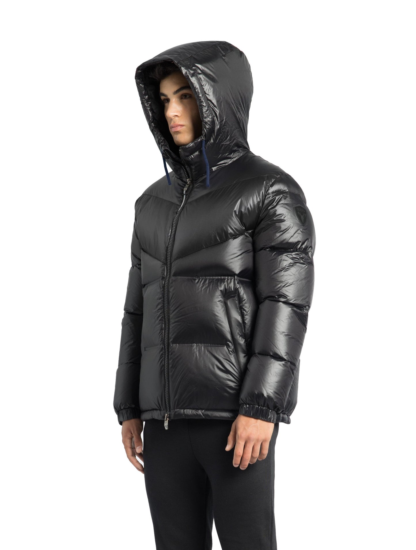 Dyna Men's Chevron Quilted Puffer Jacket in hip length, premium cire technical nylon taffeta fabrication, Premium Canadian origin White Duck Down insulation, non-removable down-filled hood, two-way centre-front zipper, fleece-lined zipper pockets at waist, pit zipper vents, in Black