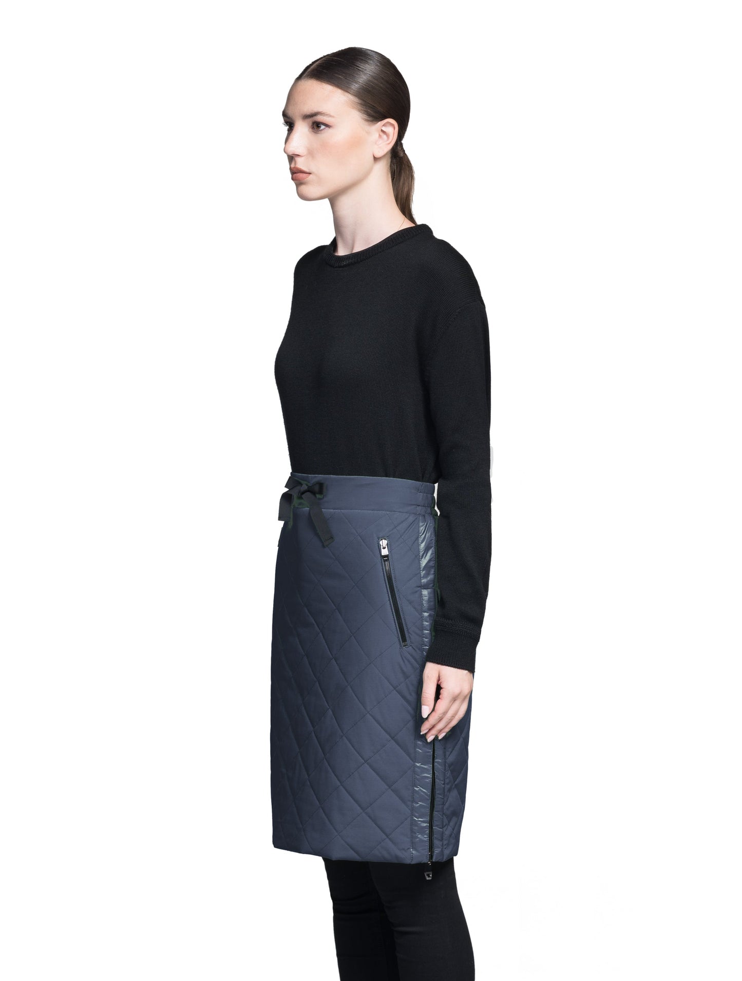 Phora Women's Tailored Skirt in knee length, premium stretch ripstop and contrast cire technical nylon taffeta fabrication, premium 4-way stretch, water resistant Primaloft Gold Insulation Active+, elasticated waistband with grosgrain ribbon drawstrings, two zipper pockets at waist, and zipper closure gusset at side seams, in Marine