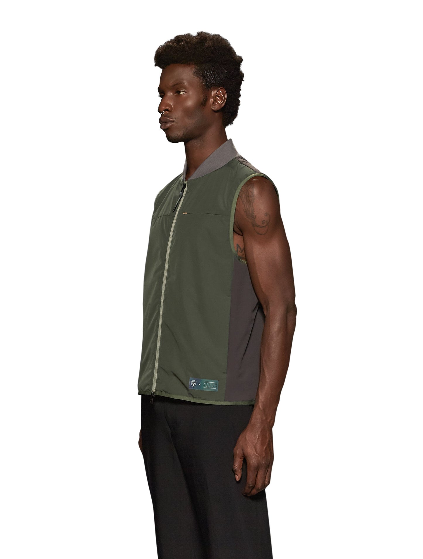 Unisex hip length vest with a contrast colour back panel, and hidden zipper pockets at waist, and an invisible zipper pocket at chest, in Fatigue/Licorice