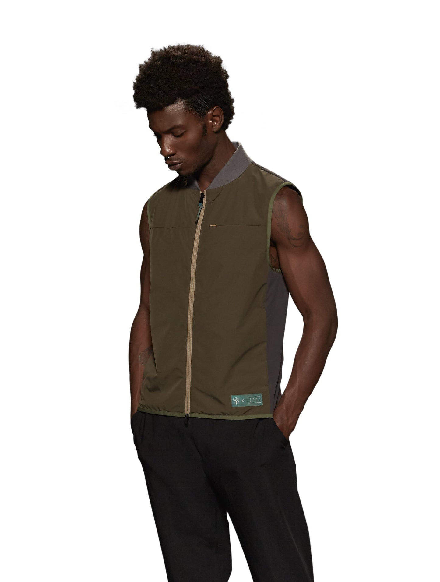 Unisex hip length vest with a contrast colour back panel, and hidden zipper pockets at waist, and an invisible zipper pocket at chest, in Fatigue/Licorice