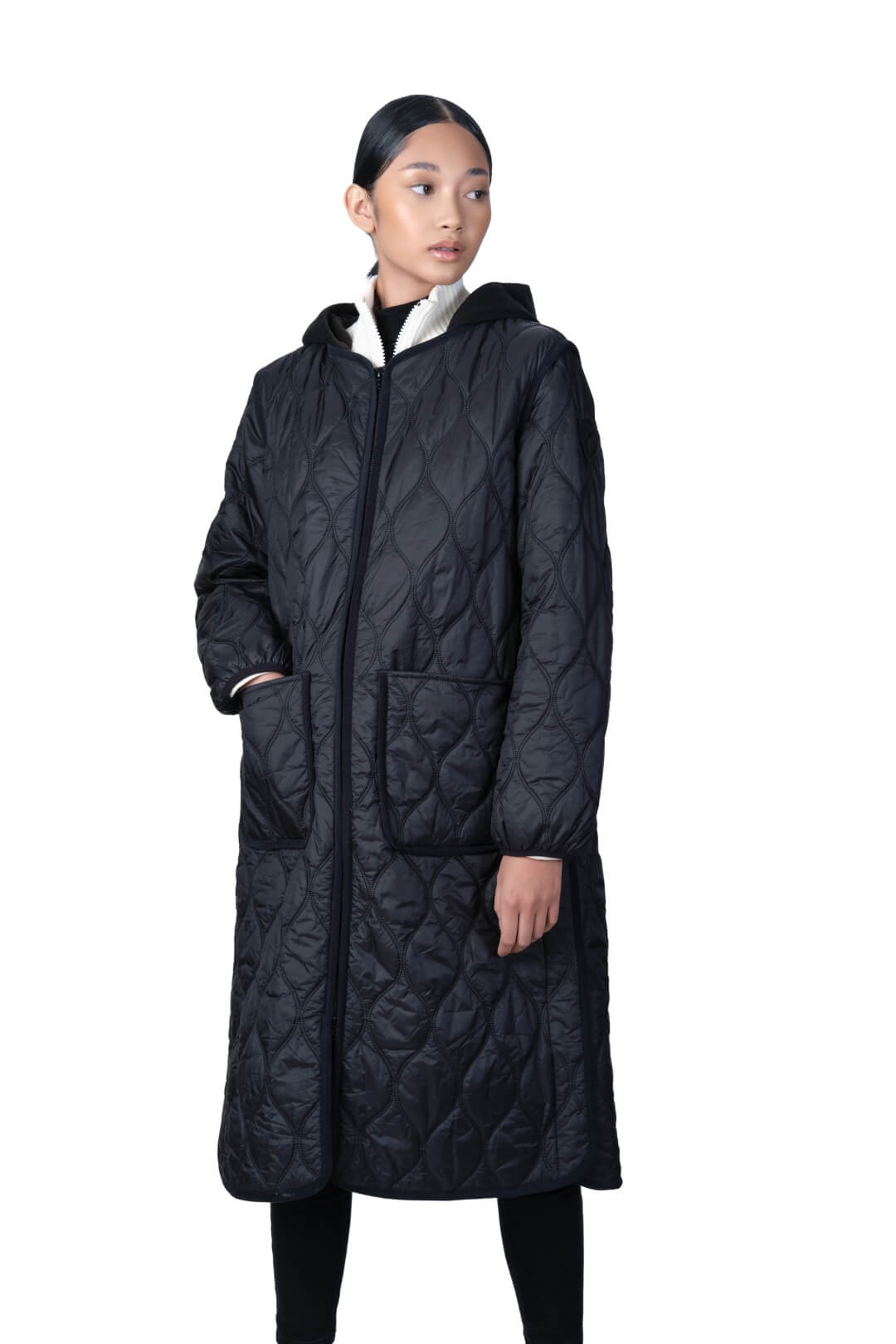 Lunar New Year Ladies Quilted Long Jacket in knee length, sustainable and environmentally friendly Primaloft Gold Insulation Active+, with removable fleece hood, two-way front zipper, two waist patch pockets, and diamond quilted body, in Black